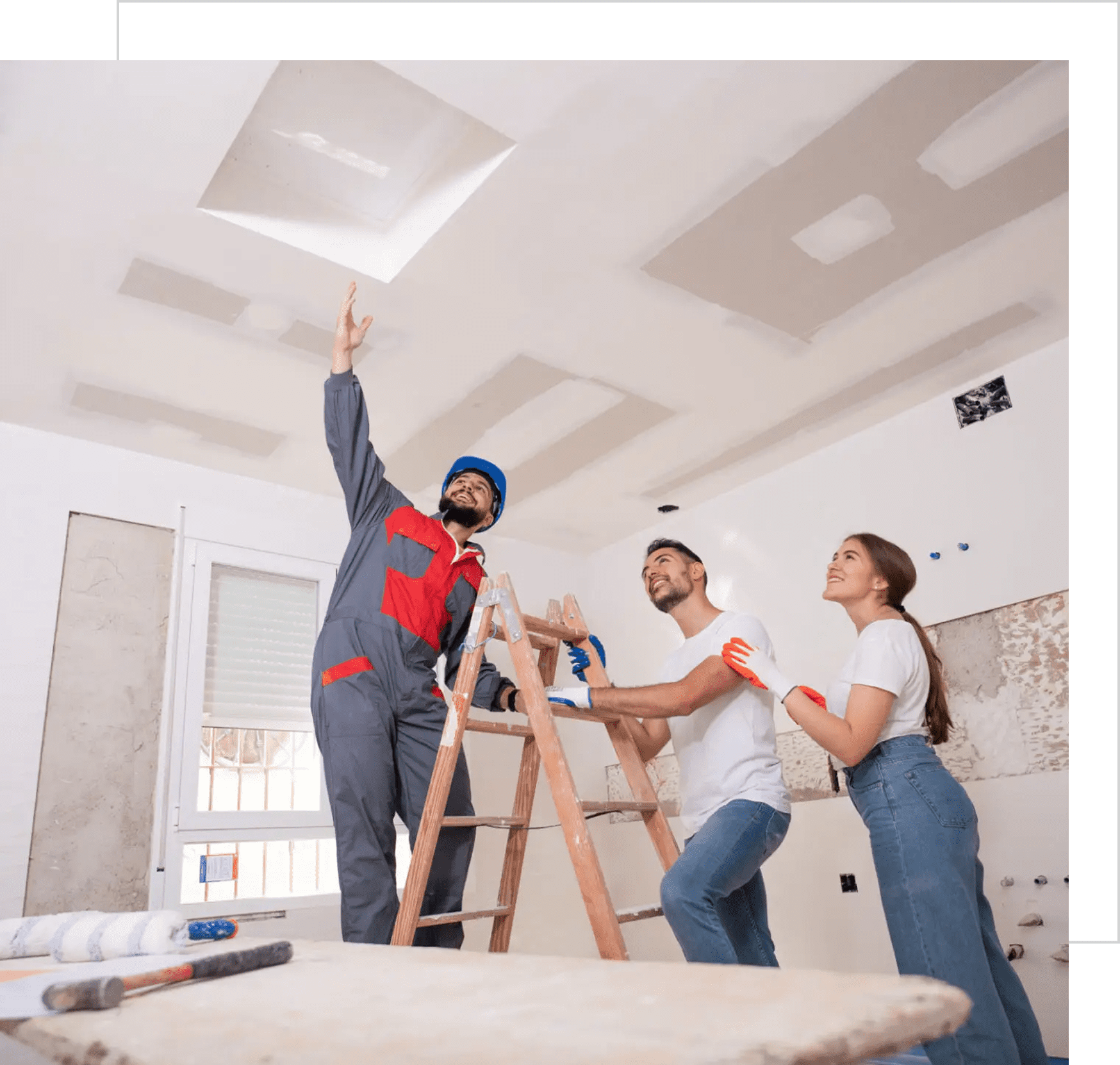 Workers inspecting ceiling renovation progress