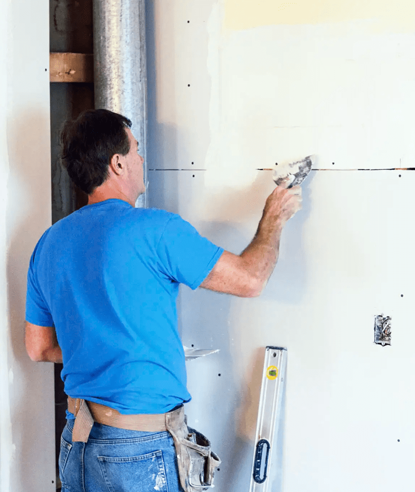 Man applying plaster to drywall