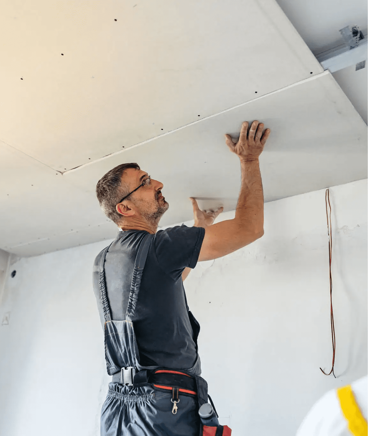 Man fitting ceiling panel