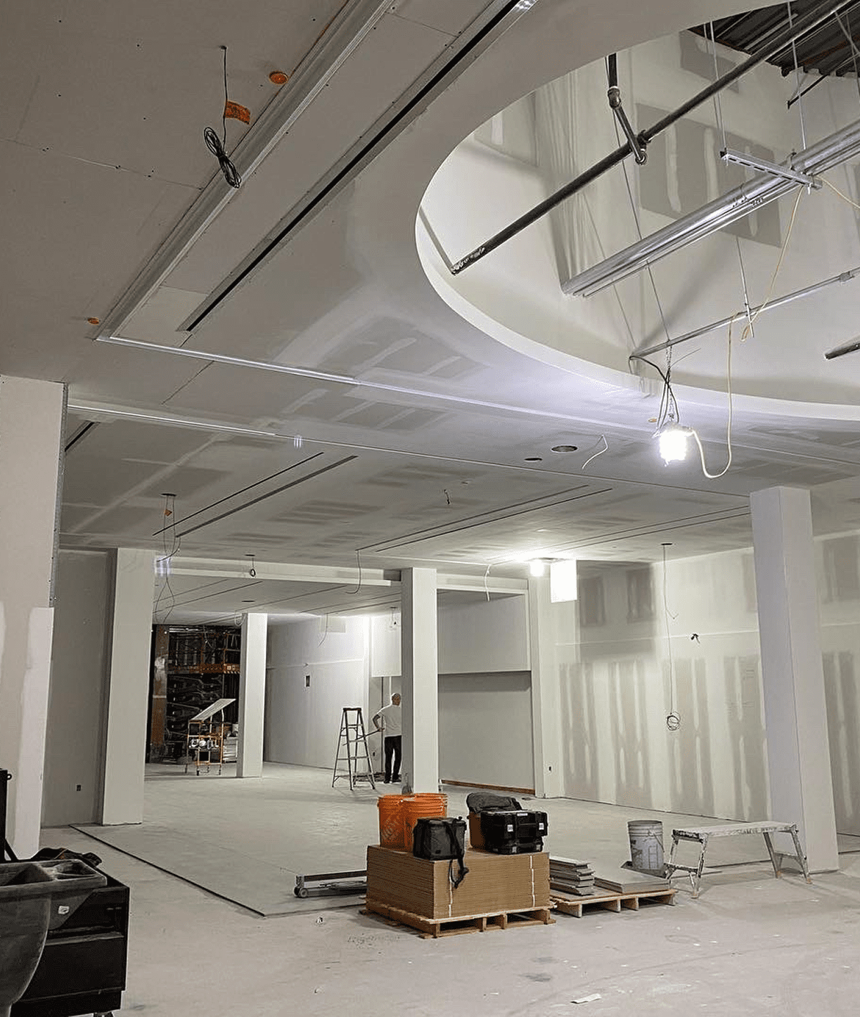 Construction site with unfinished ceiling and walls.