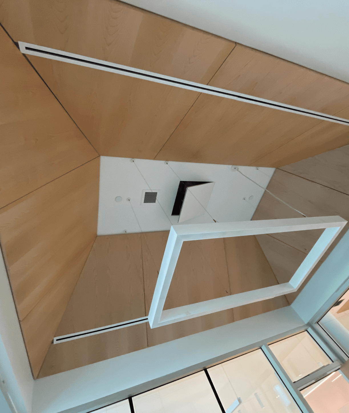 Geometric ceiling design with wooden panels.
