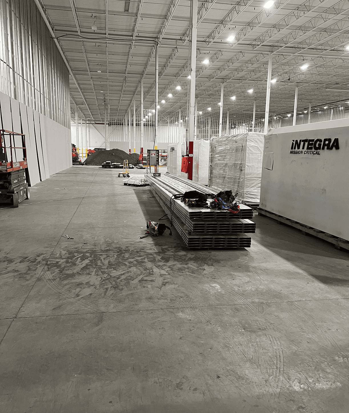 Empty industrial warehouse with stacked metal beams