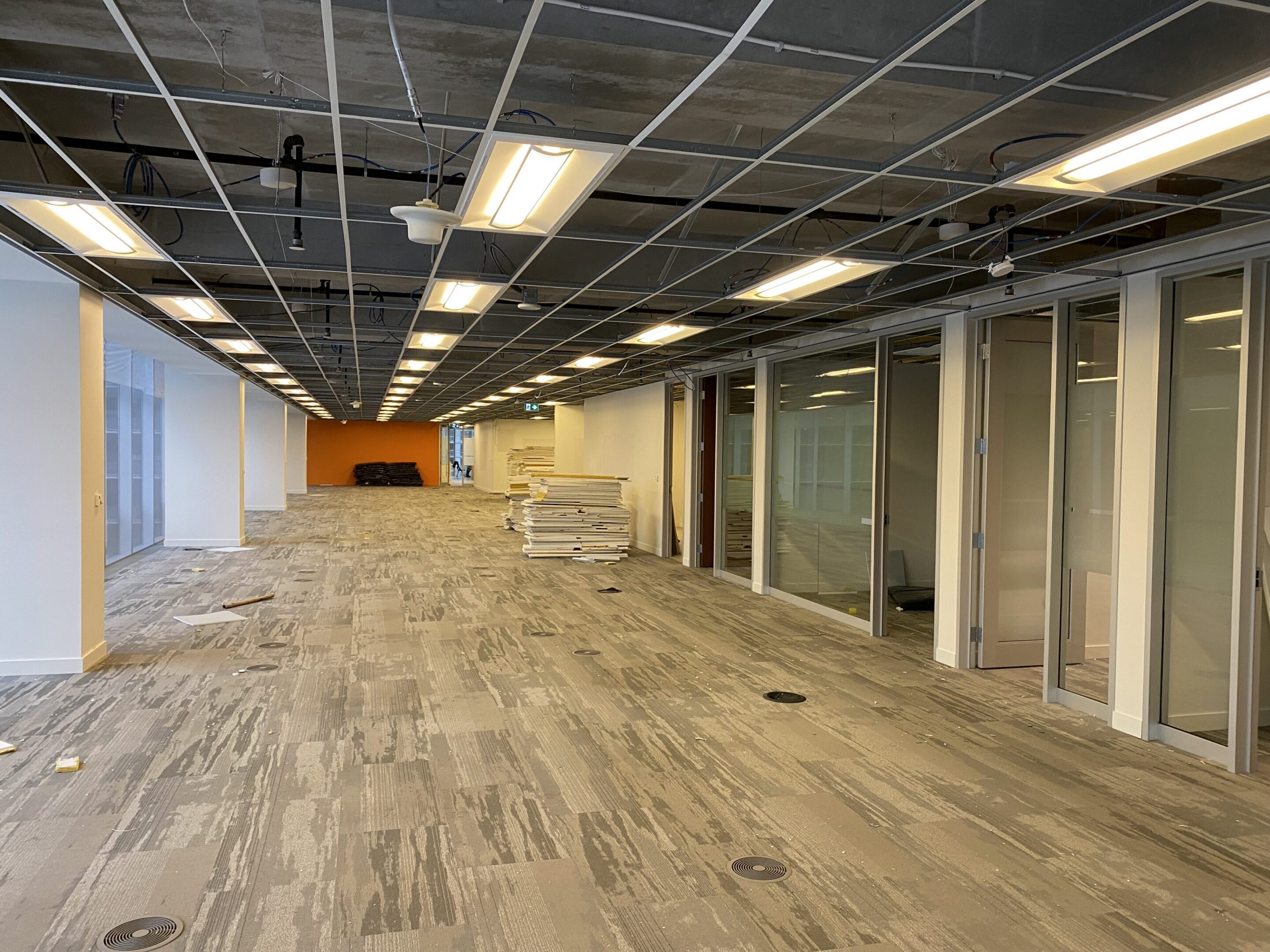 Open office space under renovation with glass offices