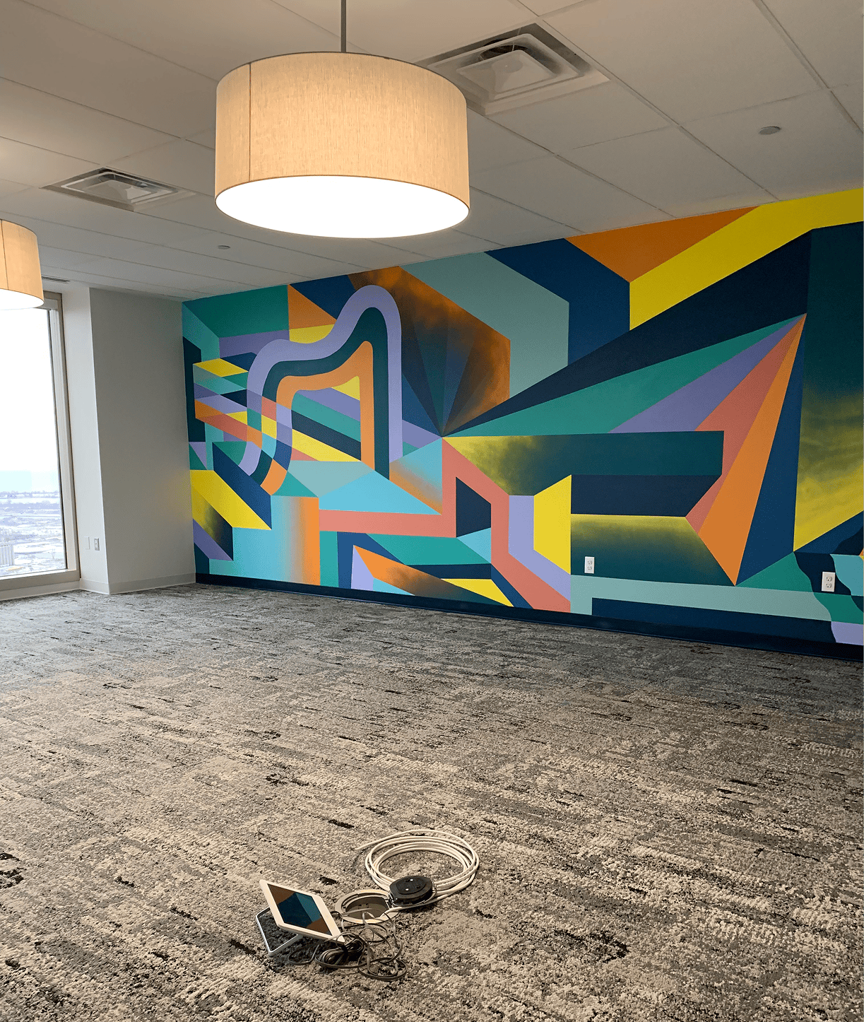 Empty office with colorful geometric mural