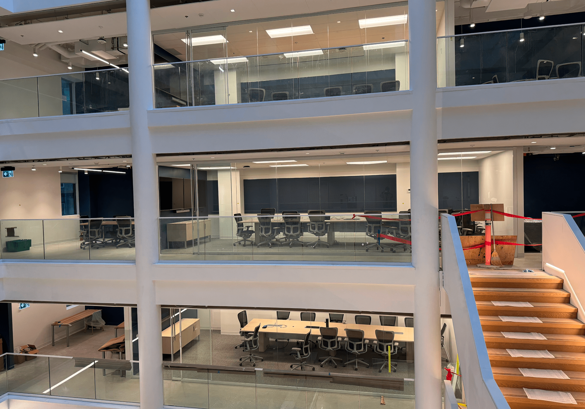 Modern multi-level office interior with staircases.