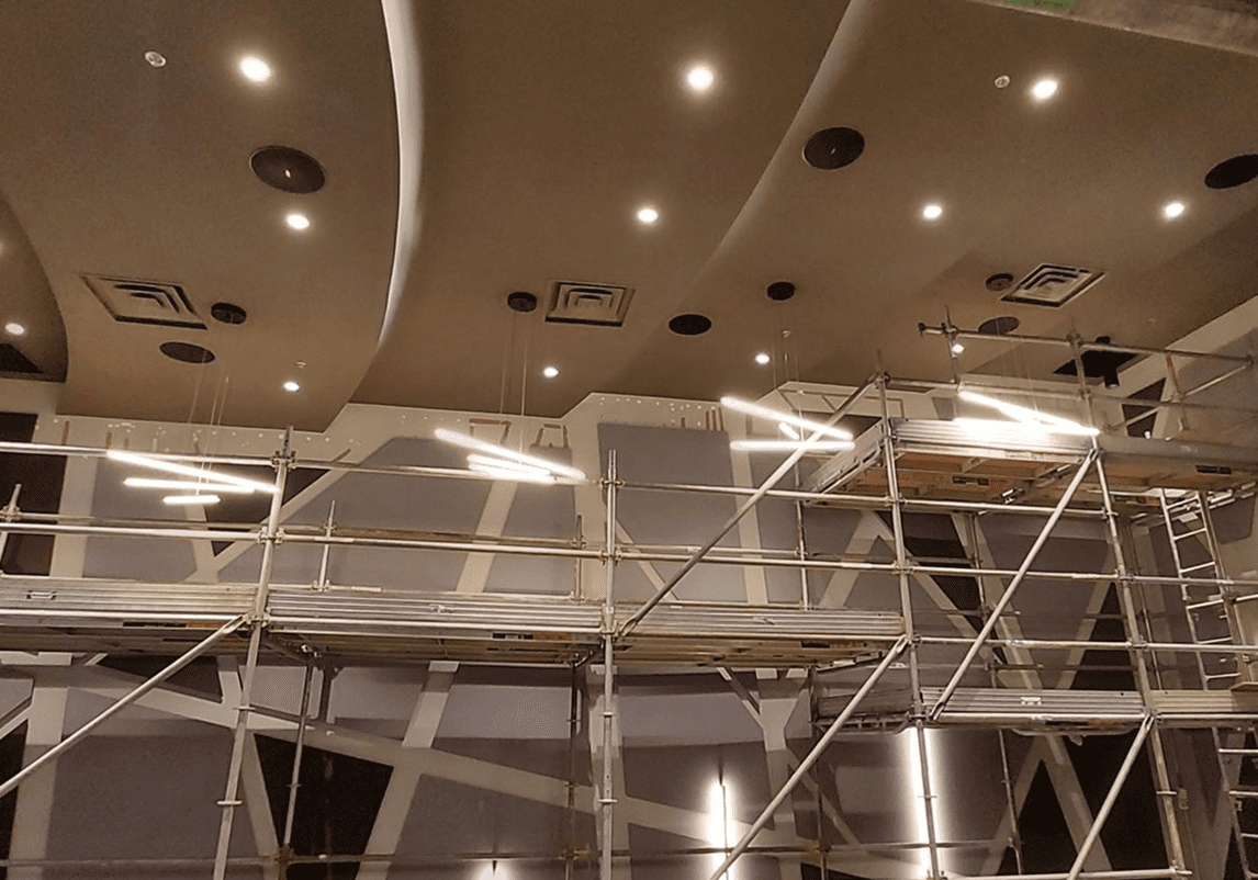 Ceiling construction with scaffolding and lights.
